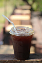 Iced americano coffee with ice on table at cafe.