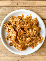 fried tempeh (tempeh penyet) in a white plate.