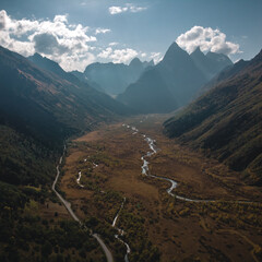 Caucasus, Dombay, a bird's-eye view of the Gonachkhir gorge, the mountains, the mountain river and the military-Sukhum road in sunny weather