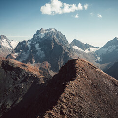 Caucasus, Dombay, a view from a drone in sunny weather on the peak of Moussa-Achitara and the people on top