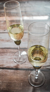 Glass of champagne isolated on wooden table. Celebrate concept
