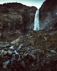 Russia, the Caucasus, Dombay, Big Sofrudjuksky (Sofrudjinsky) waterfall, powerful and high in the evening light, the dramatic landscape