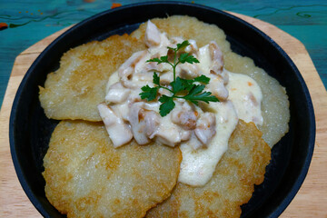 Delicious potato pancakes with mushroom gravy.