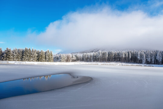 Blue ice and cracks on the surface of the ice. Frozen lake under