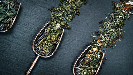 assorted tea leaves in spoons, top view