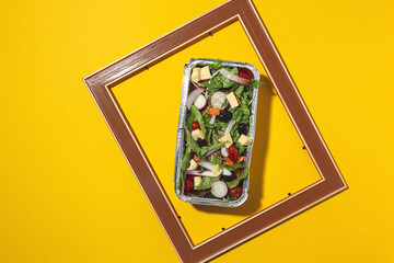 Healthy vegan take away salad in aluminum container