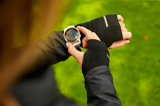An overhead shot of a woman looking at a map on her fitness watch.