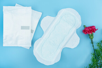 Sanitary pads and absorbent sheets on blue background