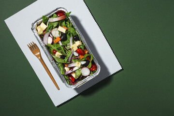 Healthy vegan take away salad in aluminum container