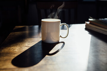 white coffee mug in morning light with steam