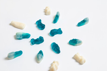Blue and white gummy candies on white background