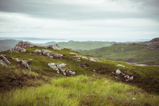 landscape scottish highlands ocean wild green grass and stone