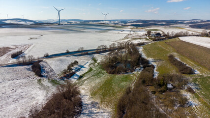 Obraz premium Aerial view of the landscape near the town of Meisenheim in winter with snow