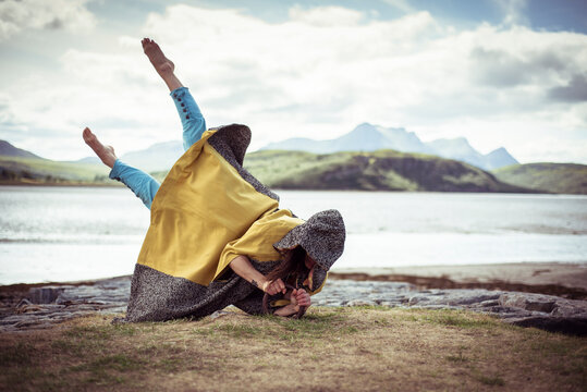 dancer seems to levitate upwards in cloak
