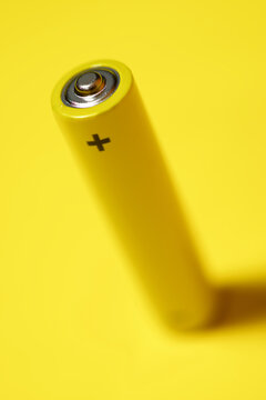 High angle view of battery on yellow background