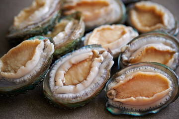 Raw abalone washed clean on marble 