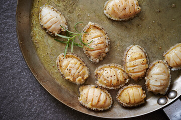 Grilled fresh abalone on a cast iron pan