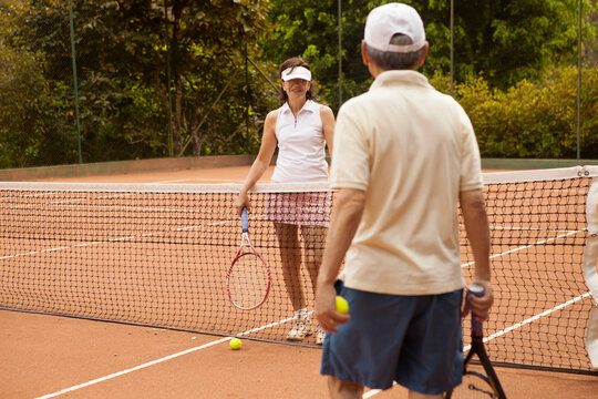 Woman looking at man while playing tennis at court