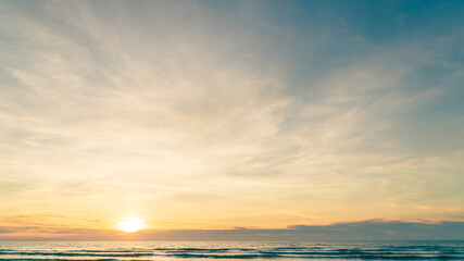 Fototapeta na wymiar Sunset sky over sea in the evening with colorful orange sunlight, dusk sky background. 