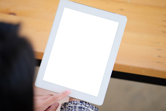 Woman Shopping On-line By Using IPad At Home.Top View Mockup Image Of A Woman Sitting And Holding Black Tablet Pc With Blank White Desktop Screen