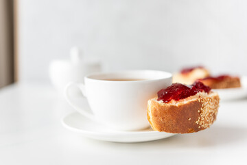 cup of tea (coffee) with bun and jam