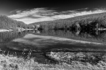 Black and white panoramic view of Lake Baccio, among the Apennine mountains in central Italy
