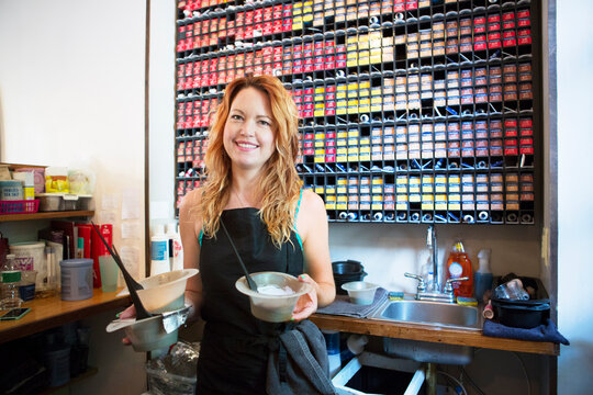 Portrait of hairdresser standing in hair salon