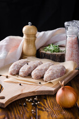 raw lazy cabbage rolls on a wooden board with peppercorns