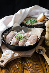 uncooked lazy cabbage rolls with onion rings and microgreens