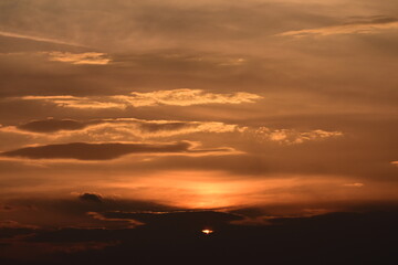 Sun low on the horizon turns sky orange