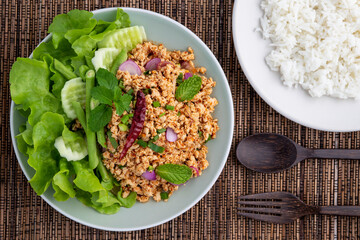 Laab gai, healthy spicy minced chicken breast salad in Isan Thai food style