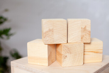 Wooden cubes on a light background. Toys for children. Ecology. Taking care of the baby. Natural and environmentally friendly. Zero wast