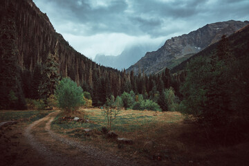 Russia, Caucasus, Dombay, the road to the Gonachkhir gorge before the rain, cloudy weather, dramatic landscape