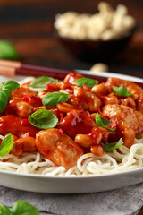 Sweet Chilli Chicken with noodles on wooden table. asian food