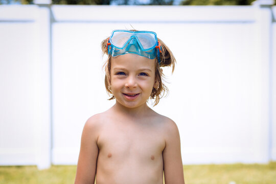 Portrait of smiling boy wearing swimming goggle on sunny day