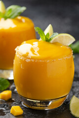 Fototapeta na wymiar Mango smoothie margarita with lime and mint. Summer cold drink with ice