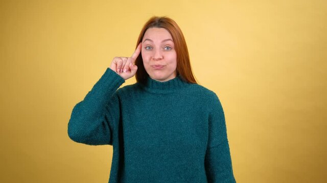 Displeased annoyed young woman showing stupid gesture, accusing crazy cuckoo mind, blaming insane idea, reckless plan, senseless dumb talk.