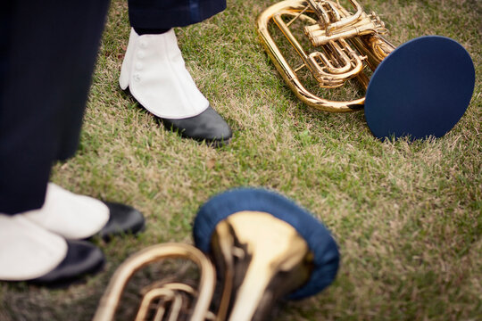 Low section of people standing by cornets on grassy field