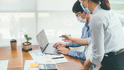 Asian People Successful Teamwork Business Wearing Medical Mask and Working. Work from Private Office Social Distancing among Coronavirus Outbreak Situation