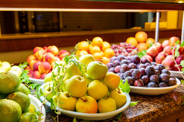 Open buffet full of delicious fruits with orange, grape, watermelon