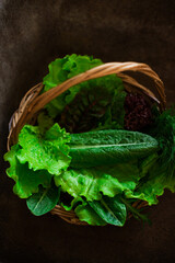 Fresh herbs in a wicker basket in the kitchen. The concept of a healthy lifestyle, healthy food, home garden, growing vegetables.