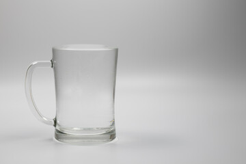 A glass with handle full of water on a white background. Space for text