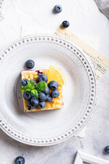 Flat lay of cake with blueberries and cottage cheese