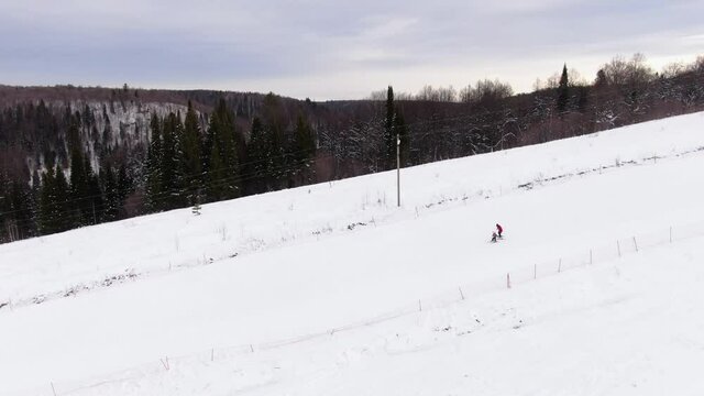 Ski school. The instructor teaches the child to ski. Aerial view