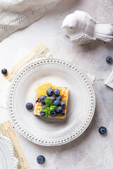 Flat lay of cake with blueberries and cottage cheese