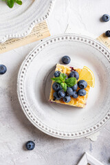 Flat lay of cake with blueberries and cottage cheese