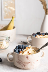 Morning breakfast with oatmeal porridge and blueberries