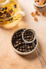 dry organic green oolong tea in a bowl on light background, top view
