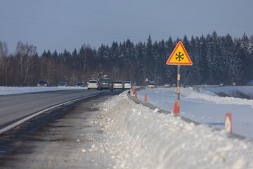 Road signs for drivers cars on the road, on a winter sunny day