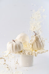 White pumpkins with splashes on white background